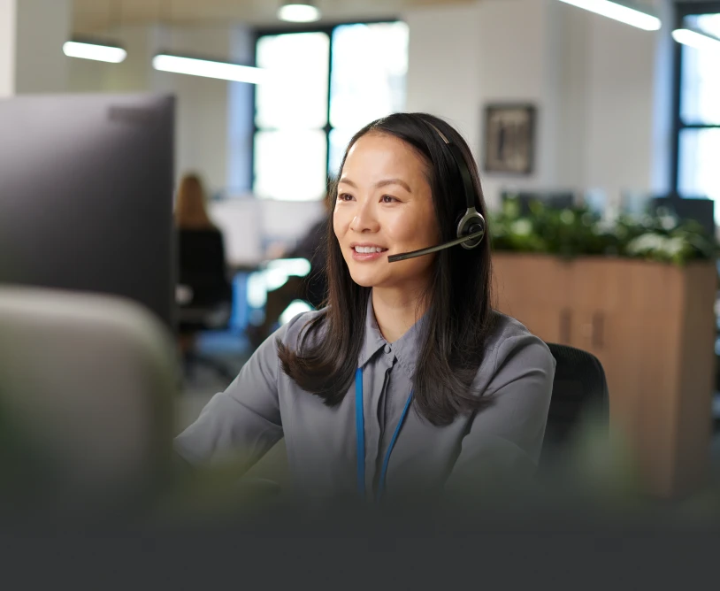Woman with headset working at computer